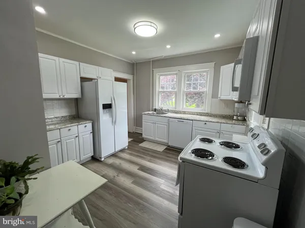 a kitchen with a stove a sink and a refrigerator