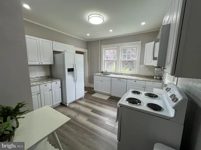 a kitchen with a stove a sink and a refrigerator