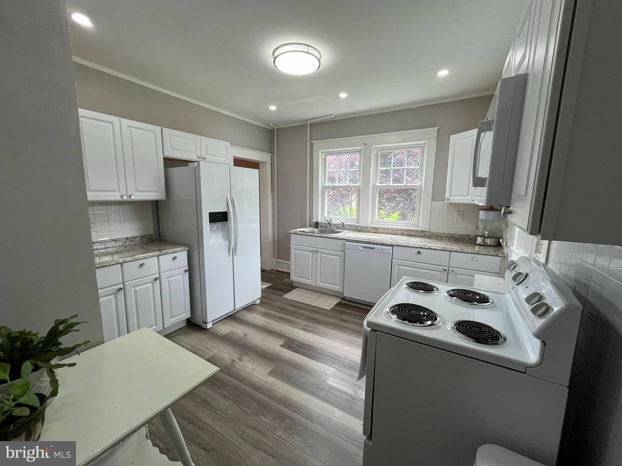 500 Delaware Avenue Delmar, DE 19940 - Photo 10 of 29 a kitchen with a stove a sink and a refrigerator