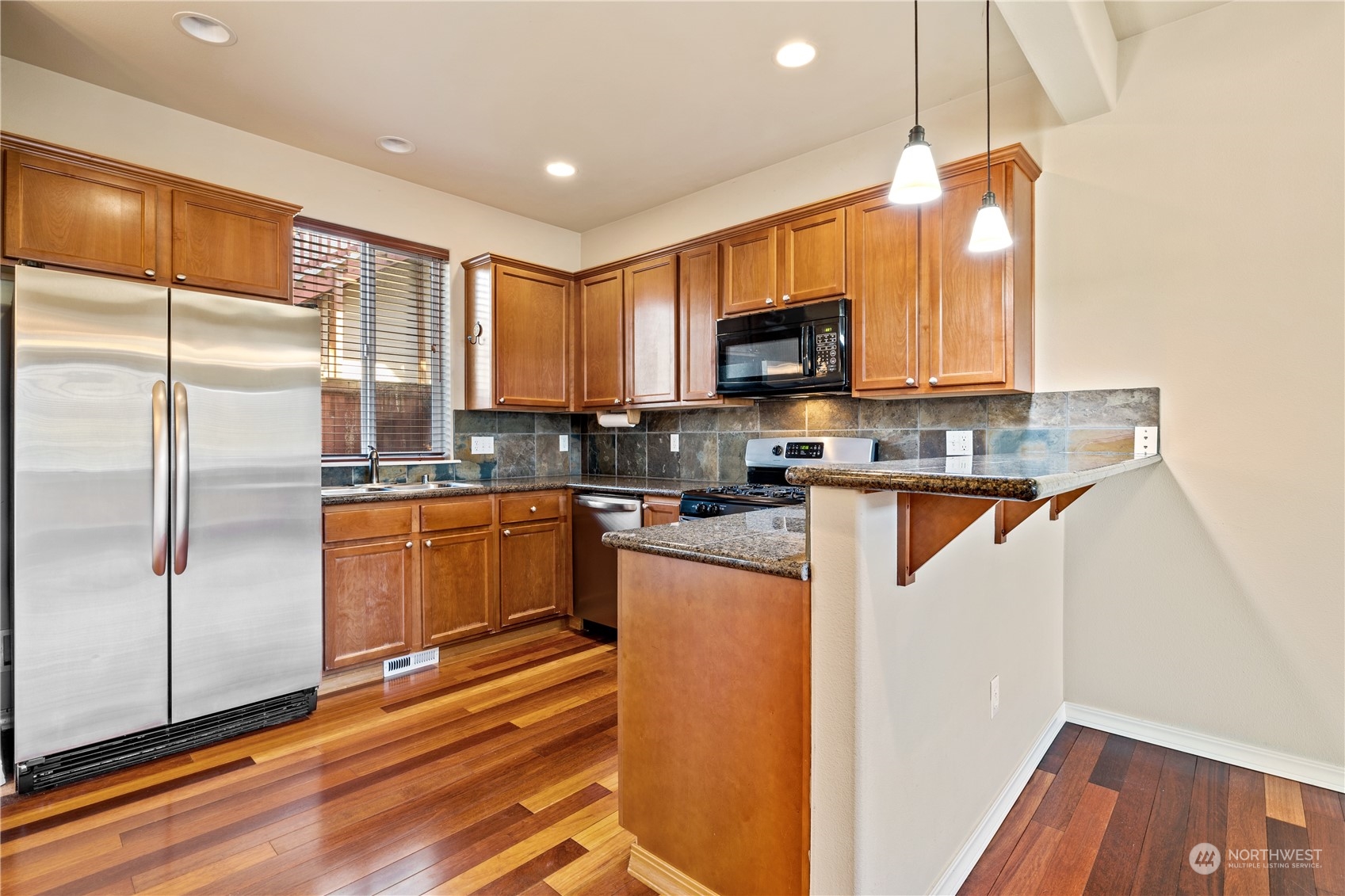 24041 40th Lane Southeast Bothell, WA 98021 - Photo 11 of 29 a kitchen with stainless steel appliances granite countertop a refrigerator a stove a sink and a microwave