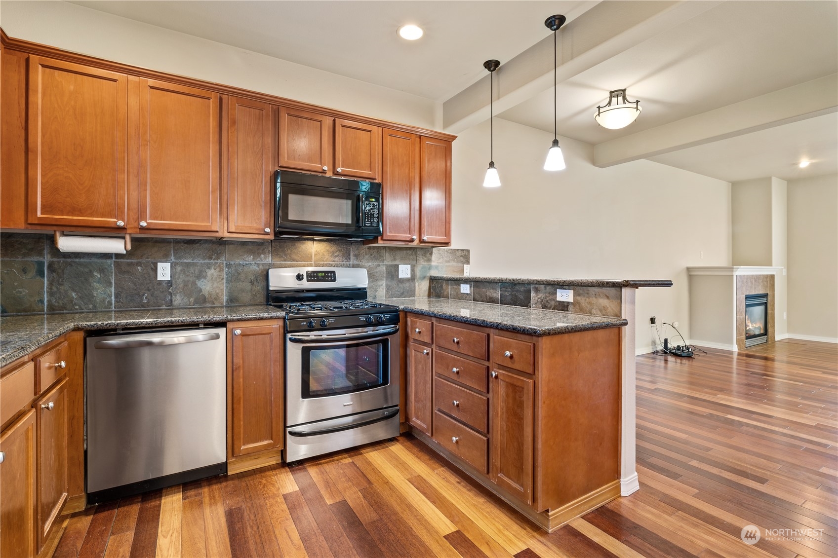 24041 40th Lane Southeast Bothell, WA 98021 - Photo 13 of 29 a kitchen with stainless steel appliances granite countertop a stove a sink and a microwave