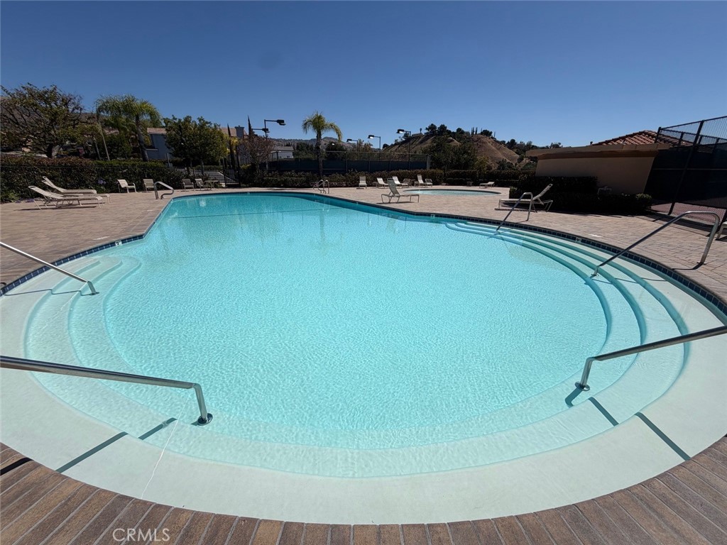 19823 Mariposa Pines Way Porter Ranch, CA 91326 - Photo 48 of 50 a view of a swimming pool and lounge chair