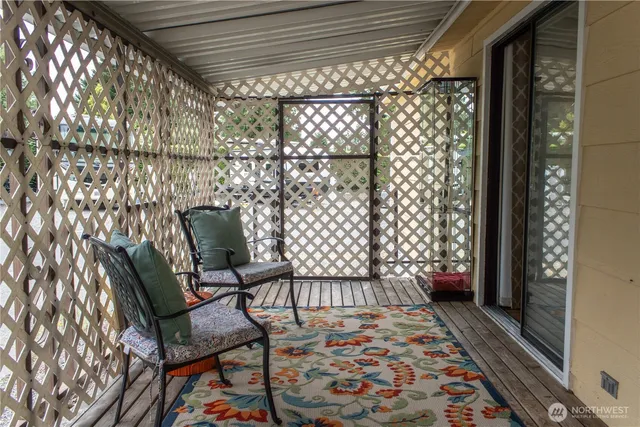 a balcony with furniture and rug