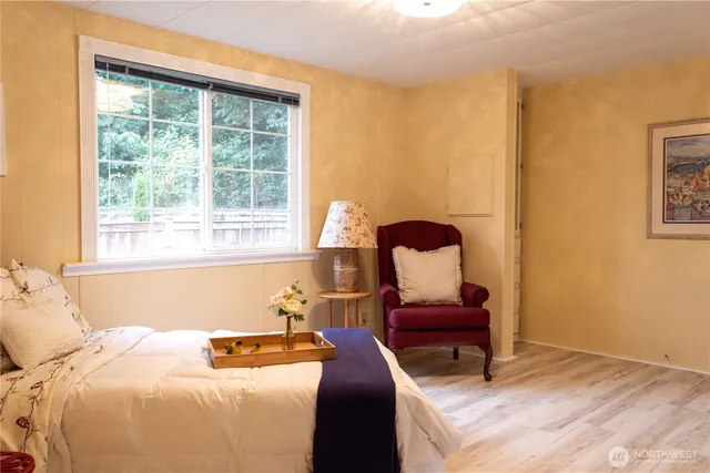 a bedroom with a bed and chair