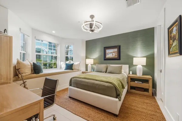 a bedroom with a bed and a desk