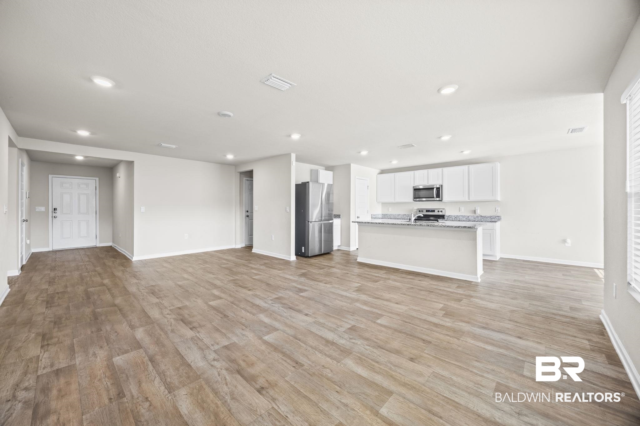3090 Camino Real Loop Lillian, AL 36549 - Photo 10 of 29 Unfurnished living room featuring light wood finished floors and recessed lighting