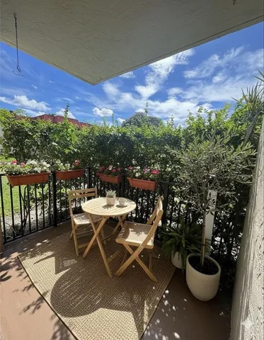 a view of a patio with table and chairs and potted plants
