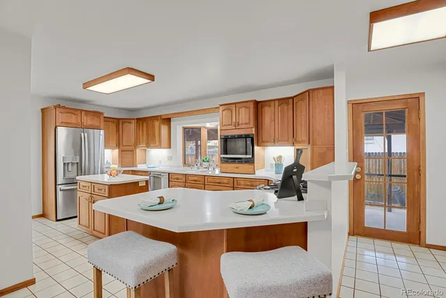a table and chairs in a room with kitchen view