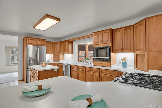 a kitchen with a stove a sink and a refrigerator