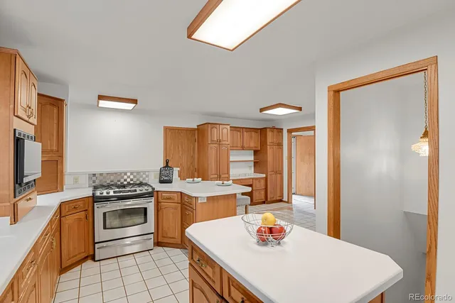 a kitchen with a stove a sink and a refrigerator