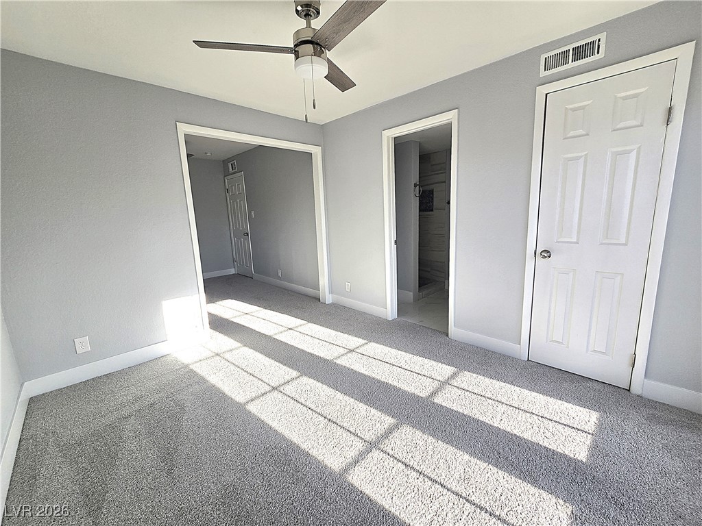 1437 Chestnut Street Henderson, NV 89011 - Photo 17 of 23 Unfurnished bedroom with carpet flooring, ensuite bathroom, and a ceiling fan