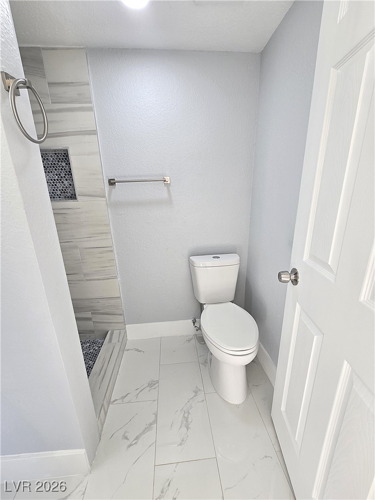 1437 Chestnut Street Henderson, NV 89011 - Photo 18 of 23 Bathroom with a shower stall and light marble finish flooring