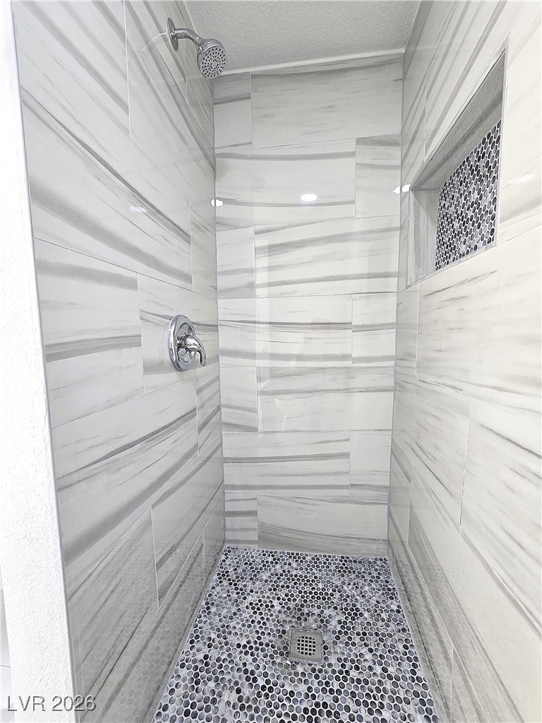 1437 Chestnut Street Henderson, NV 89011 - Photo 19 of 23 Full bathroom featuring a tile shower and a textured ceiling