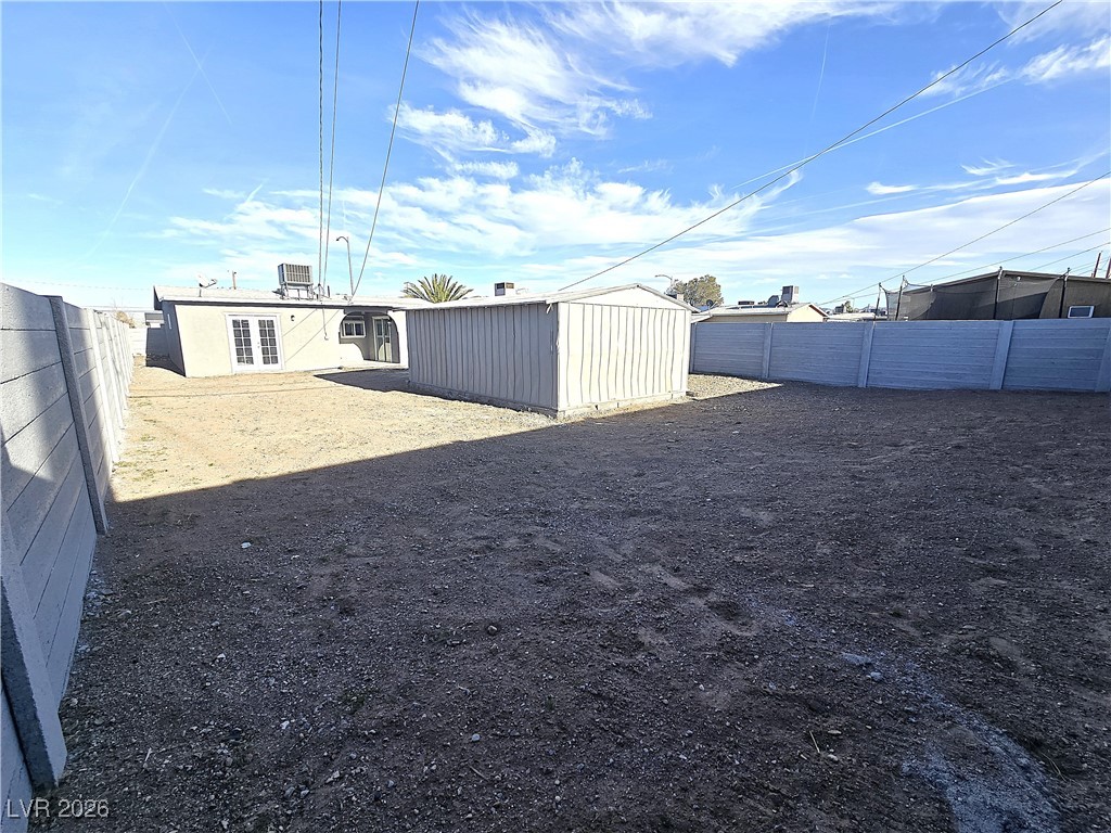 1437 Chestnut Street Henderson, NV 89011 - Photo 21 of 23 Fenced backyard featuring french doors and an outbuilding