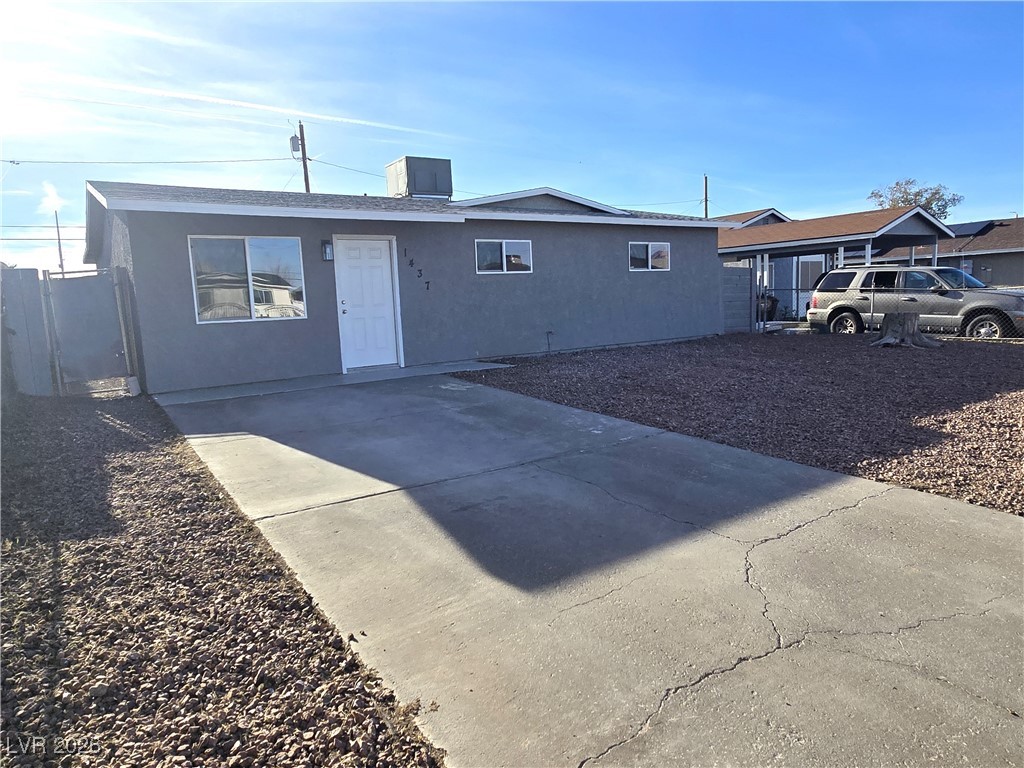1437 Chestnut Street Henderson, NV 89011 - Photo 22 of 23 View of front of house with stucco siding, concrete driveway, and a gate