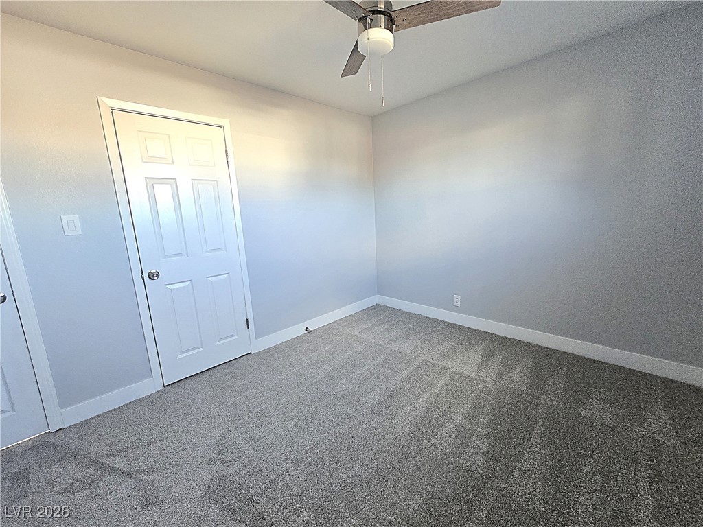 1437 Chestnut Street Henderson, NV 89011 - Photo 10 of 23 Unfurnished room featuring carpet and a ceiling fan