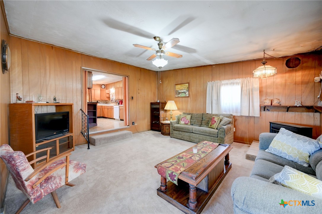 1631 East Fannin Street Luling, TX 78648 - Photo 11 of 27 a living room with furniture a ceiling fan and a flat screen tv