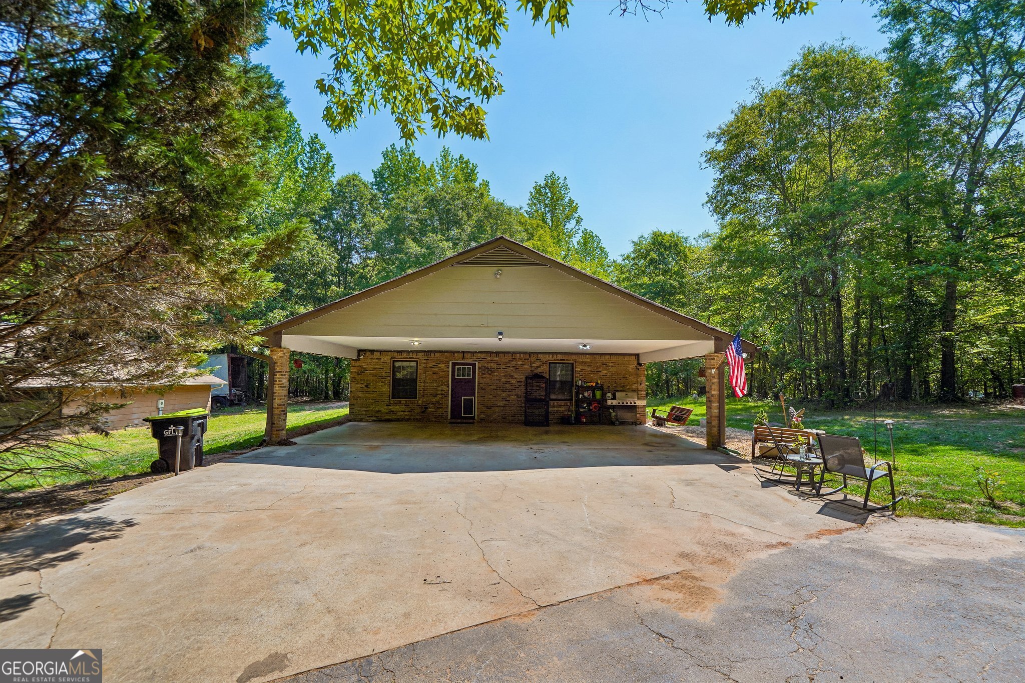 241 Busbin Road Fayetteville, GA 30215 - Photo 26 of 45 a view of a house with patio area and a garden