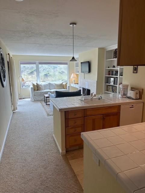 101 Shell Road, Unit 106 Watsonville, CA 95076 - Photo 13 of 16 a kitchen with a stove a sink a dining table and chairs
