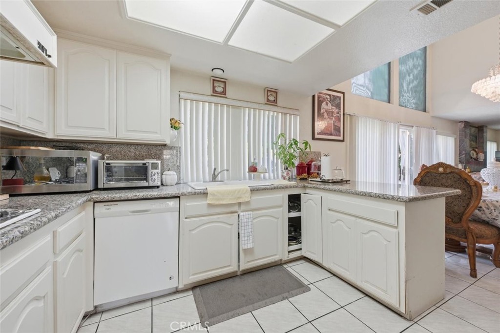 6266 Shaker Drive Riverside, CA 92506 - Photo 15 of 72 a kitchen with granite countertop white cabinets and white appliances