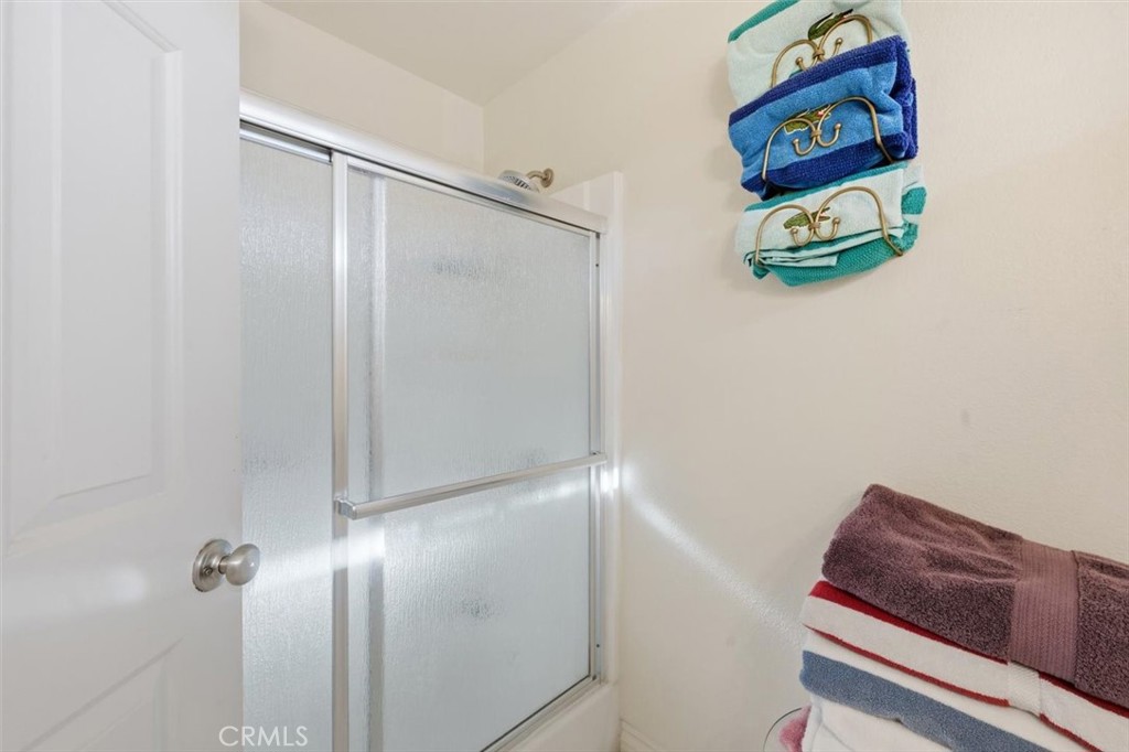 6266 Shaker Drive Riverside, CA 92506 - Photo 38 of 72 a bathroom with a shower and a glass door