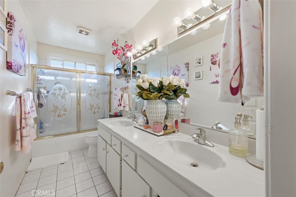 6266 Shaker Drive Riverside, CA 92506 - Photo 43 of 72 a bathroom with a sink a vanity and a mirror