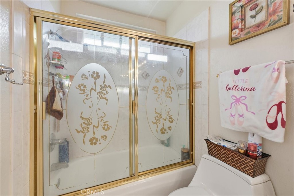 6266 Shaker Drive Riverside, CA 92506 - Photo 44 of 72 a bathroom with a glass shower door