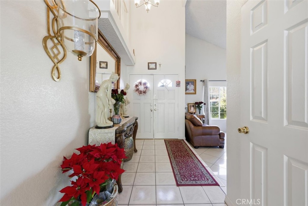 6266 Shaker Drive Riverside, CA 92506 - Photo 8 of 72 a hallway with a table and a chandelier