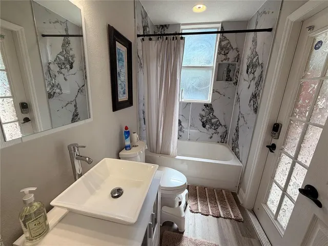 a bathroom with a bathtub a sink and a shower