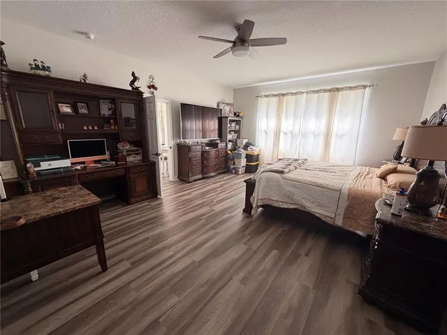a bedroom with a bed window and a television