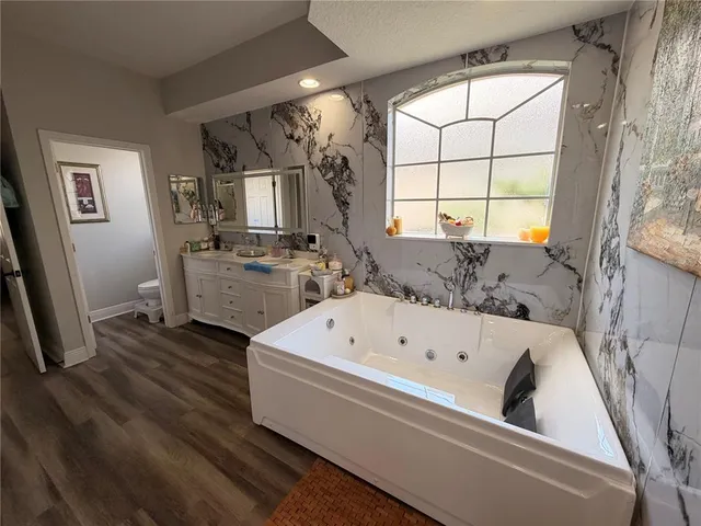 a bathroom with a bathtub and a window