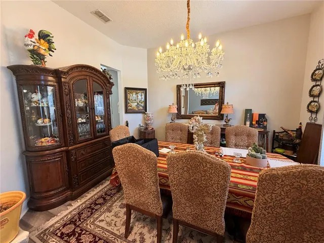 a living room with fireplace furniture and a chandelier