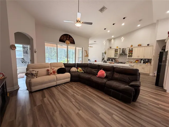 a living room with furniture and wooden floor