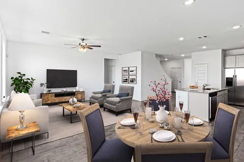 a living room with furniture kitchen view and a flat screen tv