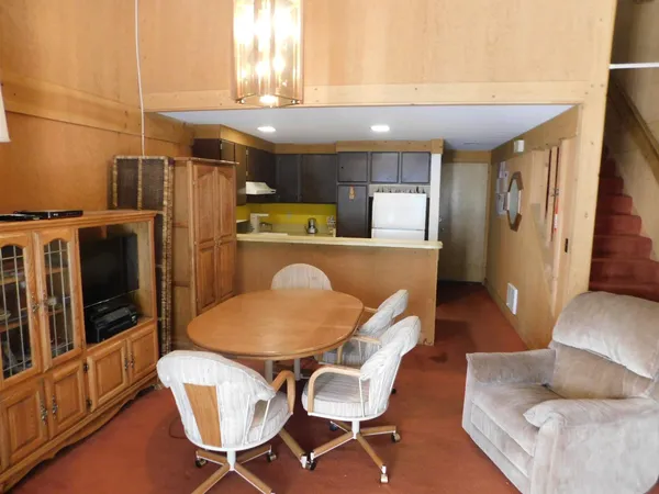 a dining room with furniture and wooden floor