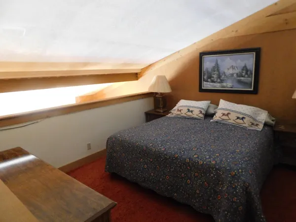 a bedroom with a bed and a night stand