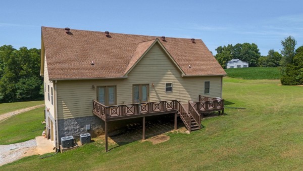 4664 New Cut Road Greenbrier, TN 37073 - Photo 68 of 85 a view of a house with a yard chairs and floor to ceiling window