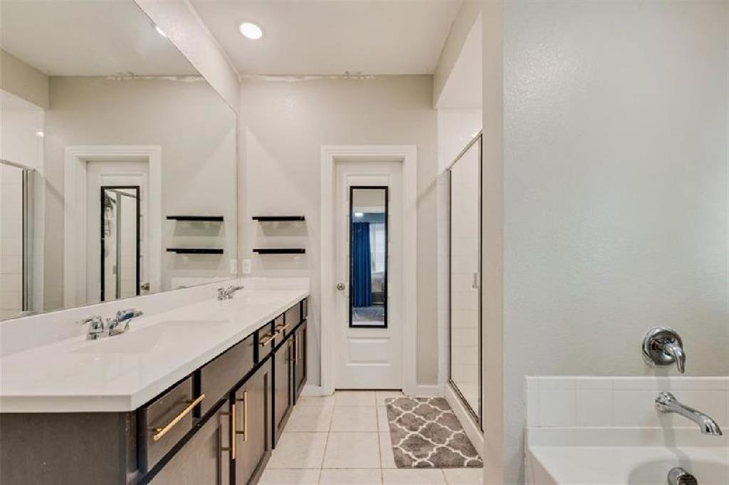 3911 Rochelle Lane Crandall, TX 75114 - Photo 13 of 16 a bathroom with a tub sink and mirror