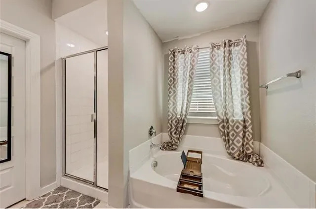 a bathroom with a bathtub and a shower