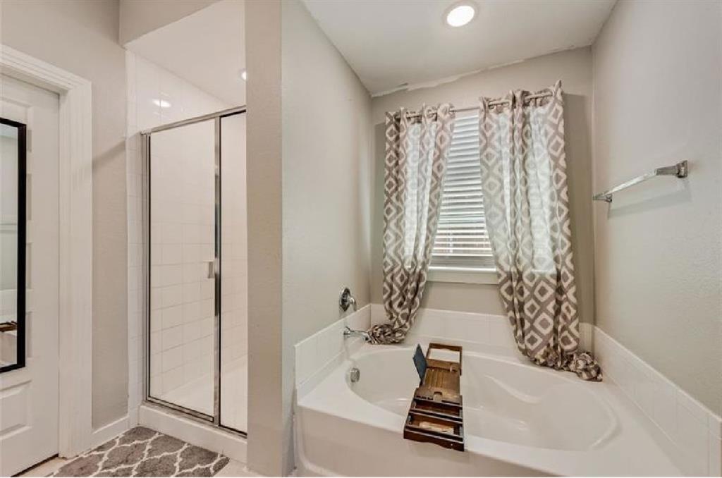 3911 Rochelle Lane Crandall, TX 75114 - Photo 14 of 16 a bathroom with a bathtub and a shower