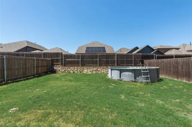 a view of a house with backyard and sitting area