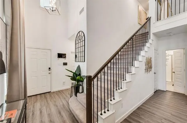 a view of entryway and hall with wooden floor