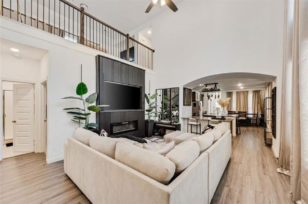 3911 Rochelle Lane Crandall, TX 75114 - Photo 5 of 16 a living room with furniture a chandelier and a flat screen tv