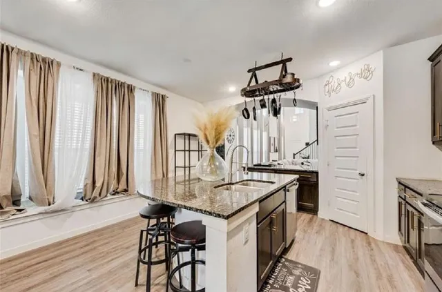 a kitchen with stainless steel appliances granite countertop a stove and a refrigerator