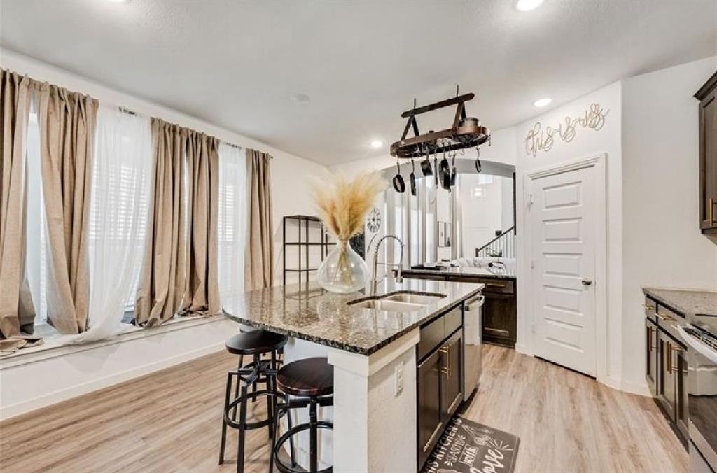 3911 Rochelle Lane Crandall, TX 75114 - Photo 9 of 16 a kitchen with stainless steel appliances granite countertop a stove and a refrigerator