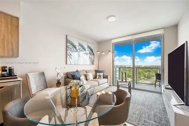 a living room with furniture large window and a flat screen tv