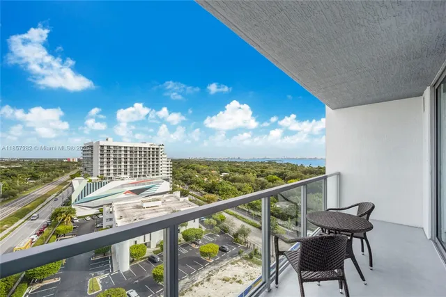 a view of a balcony with chair and wooden floor