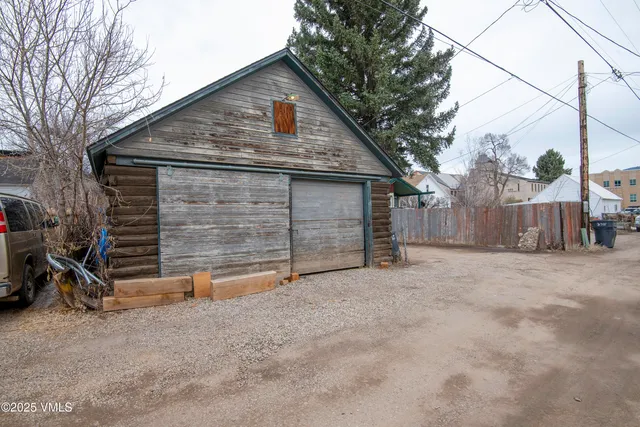 a view of backyard with small cabin