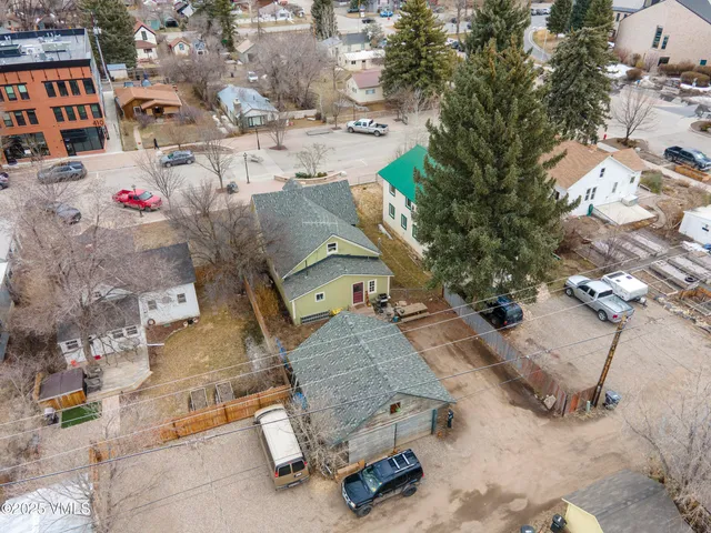 an aerial view of residential houses with outdoor space