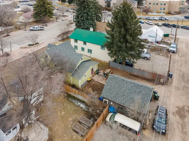 an aerial view of a house with a yard